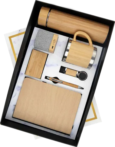 a wooden hamper in a box which have a dairy, pen, a cup and a bamboo bottle